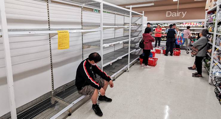 customers stand by empty supermarket shelves