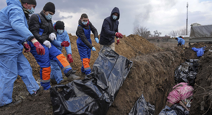 Dead bodies placed into a mass grave on the outskirts of Mariupol, Ukraine, March 2022 (Image: AAP/AP/Evgeniy Maloletka)