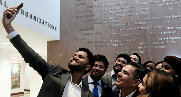 US Congressman-elect Maxwell Frost (left) takes a selfie with other newly elected representatives (Image: Reuters/Michael A McCoy)