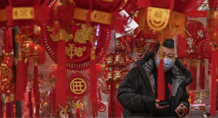 A man shops for Chinese Lunar New Year decorations in Beijing (Image: AAP/AP/Andy Wong)