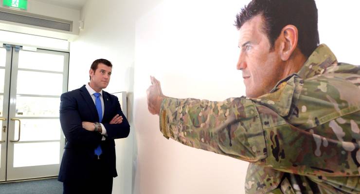 Ben Roberts-Smith studies the portrait of himself at the Australian War Memorial