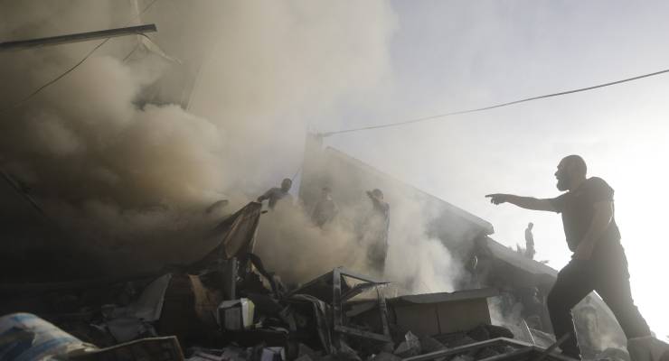Palestinians look for survivors of a bombed building following an Israeli airstrike on Gaza