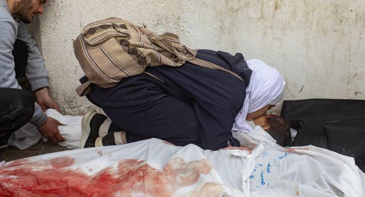 A mother next to the body of her daughter, killed in an Israeli air strike in Rafah, February 12 (Image: EPA/Haitham Imad)