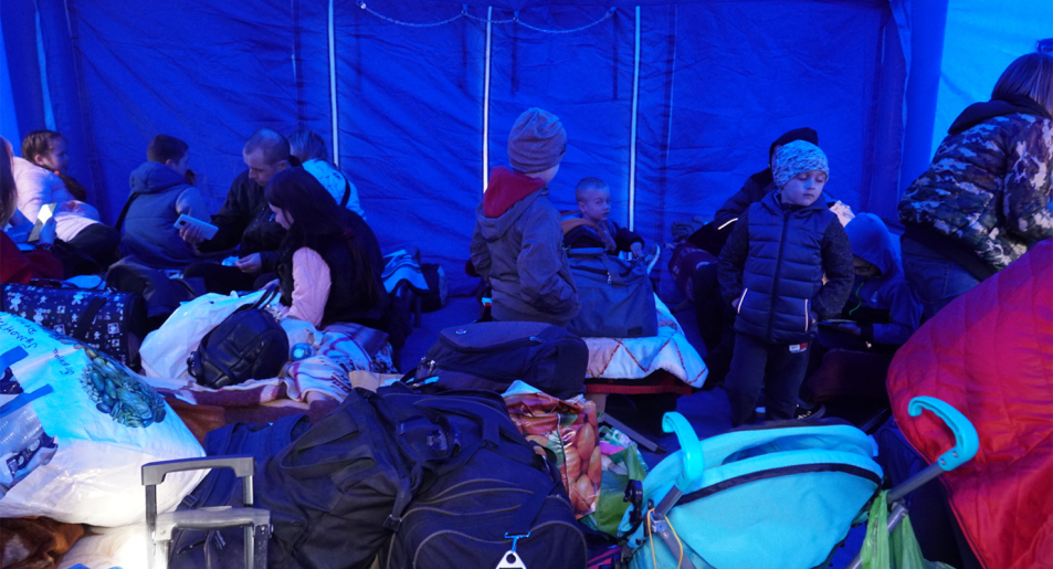 Blue tents offer safe havens for those who have just crossed the border in Romania (Image: Amber Schultz/Private Media)