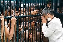 Chalida Thacharoensak, of People’s Empowerment, a human rights group, greets Rohingya immigrants during her visit to a detention centre at the Immigration Bureau in Bangkok