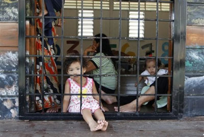 In this photo taken on July 23, children detainees look out through their shelter at the Lenggeng detention center, south of Kuala Lumpur, Malaysia. (Photo:AP) 